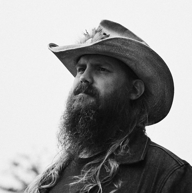 Chris Stapleton singing and playing guitar on stage during his All-American Road Show tour
